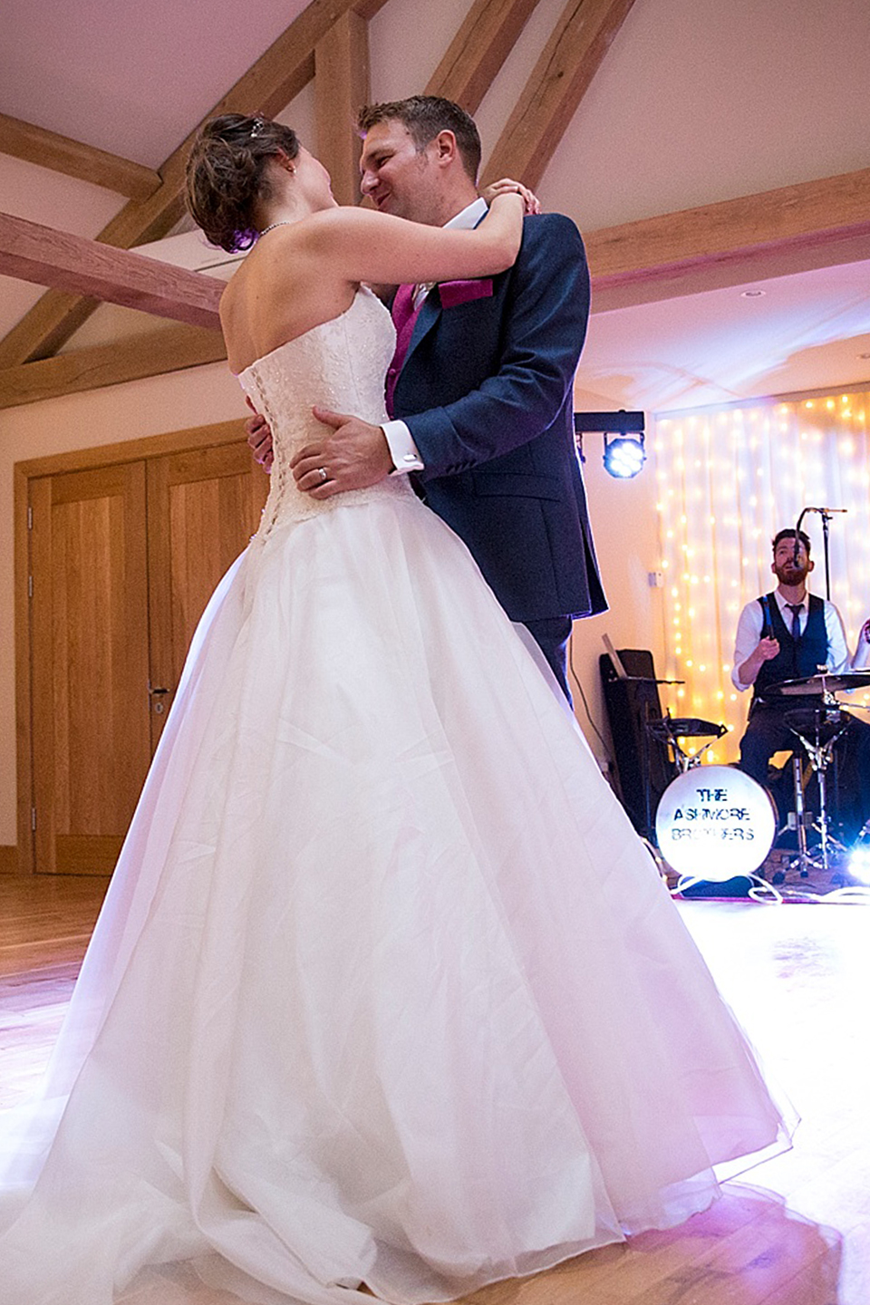 The newlyweds have their first dance as husband and wife inside the stunning barn wedding venue