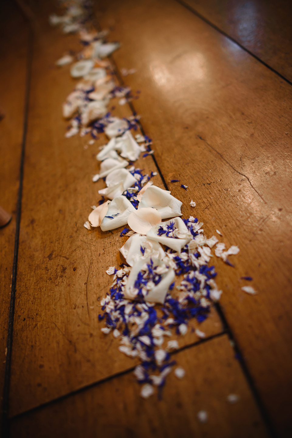 Dried petals lined the wedding aisle in the Rickety Barn for the wedding ceremony