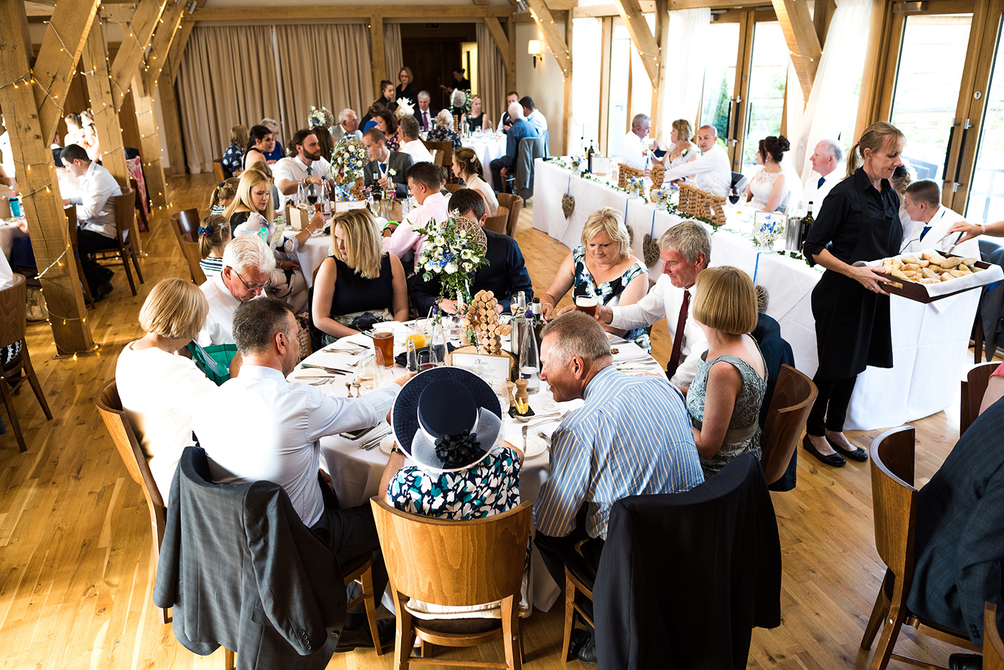 The happy couple and their guests sit down to enjoy a fabulous wedding breakfast cooked and served by the expert on-site catering team