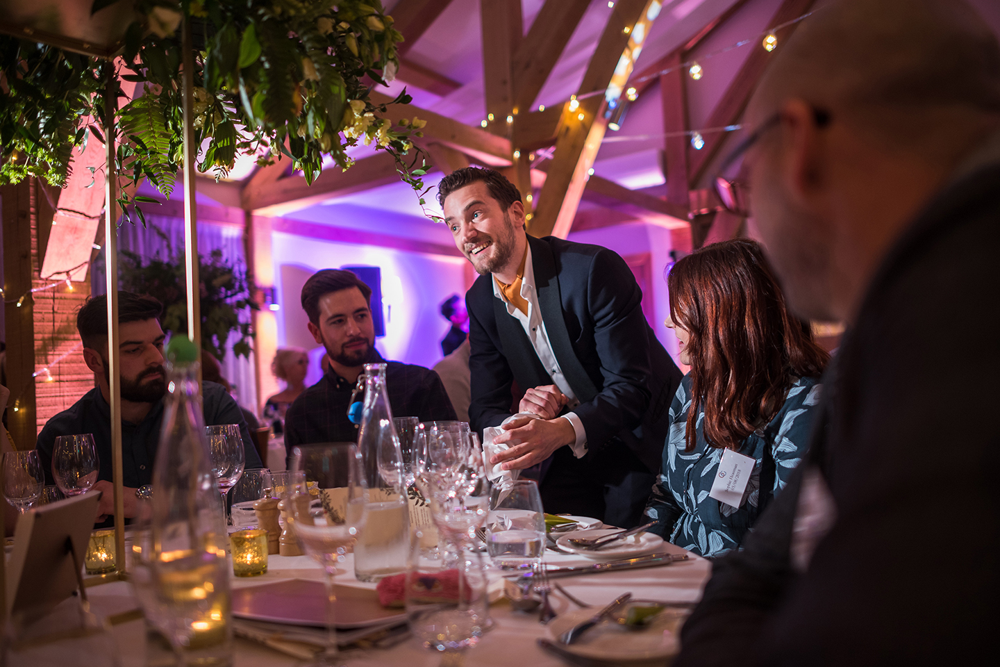 A wedding magician entertains guests during a tasting event at Bassmead Manor Barns