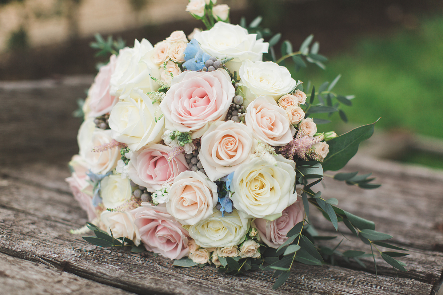 A spring wedding bouquet is made up of pastel florals for a wedding ceremony at Bassmead Manor Barns