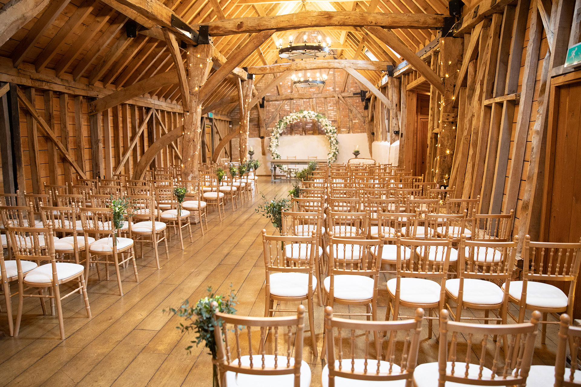 The Rickety Barn at this Cambridgeshire wedding venue is set up for an intimate wedding ceremony