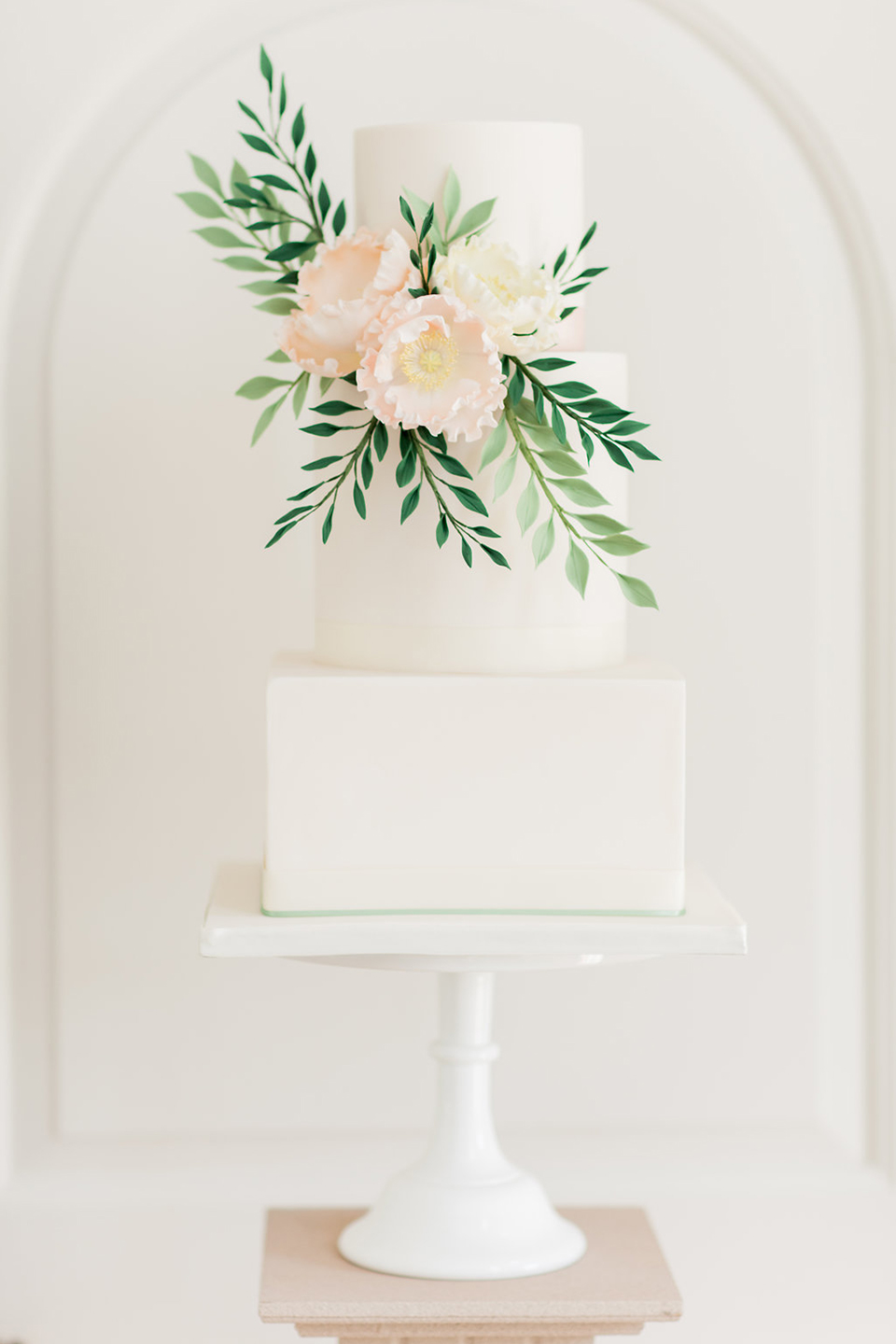 A modern square wedding cake is a great twist on a traditional cake and fits in well with the barns at Bassmead Manor Barns