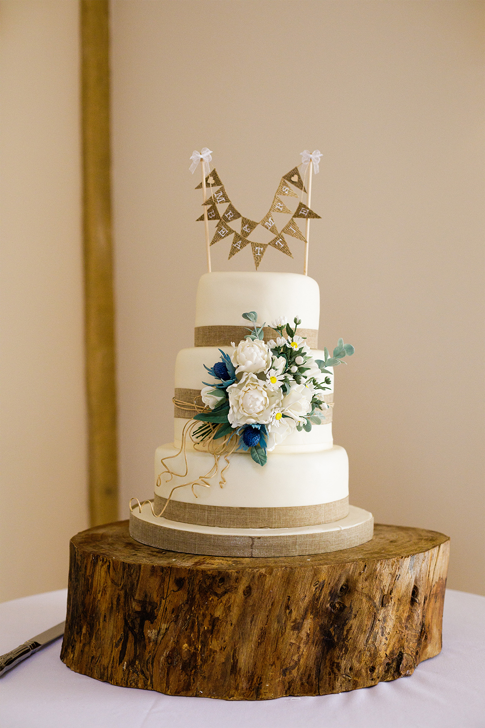 A bunting cake topper is perfect for a rustic wedding at Bassmead Manor Barns