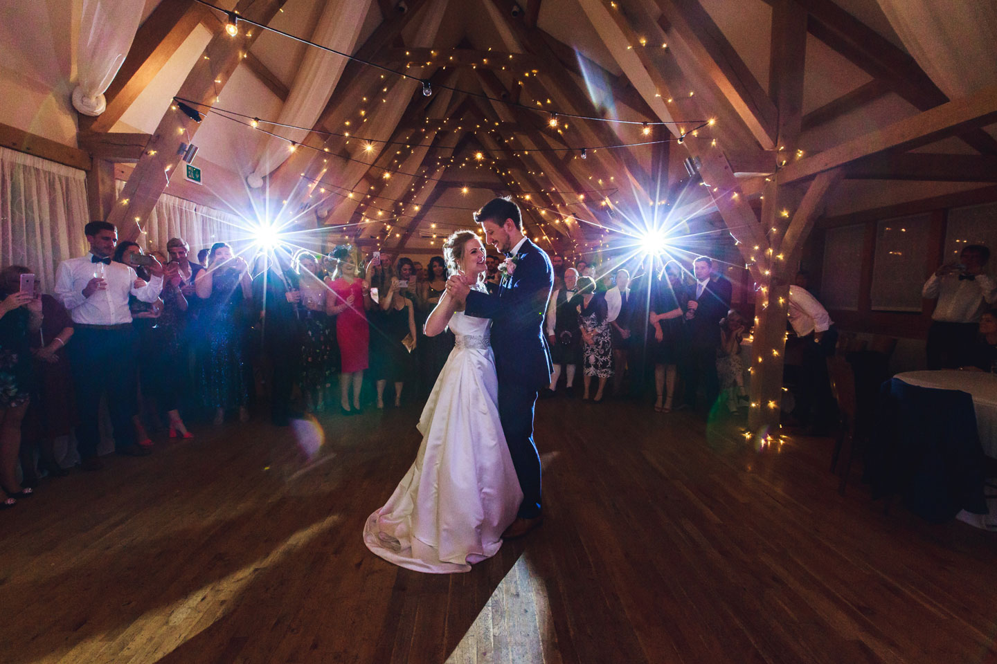 The happy newlyweds enjoy their first dance doughnut-wall-wedding-ideas